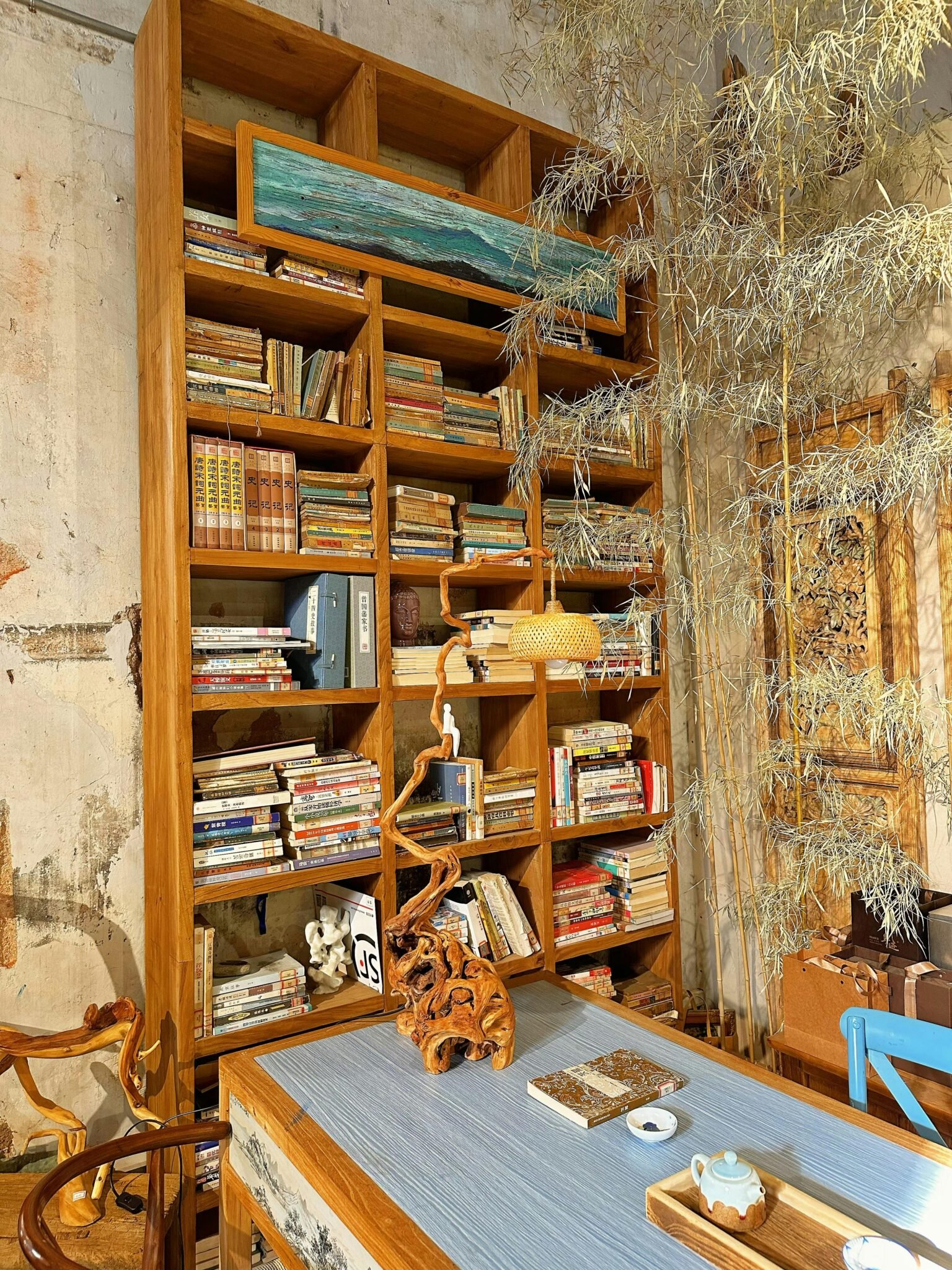 Warm, inviting home library setting with wooden shelves filled with books and rustic decor.