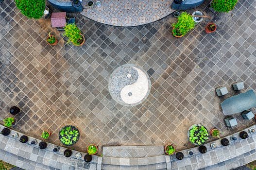 Aerial shot of outdoor space with Yin Yang symbol surrounded by potted plants in Banten, Indonesia.